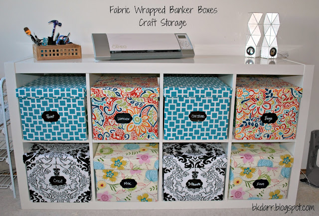 fabric covered banker boxes. good idea! fabric storage