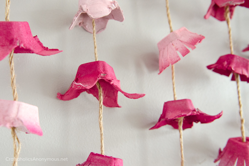 DIY Egg Carton flowers turned into a pretty Boho wall hanging. A must see! 