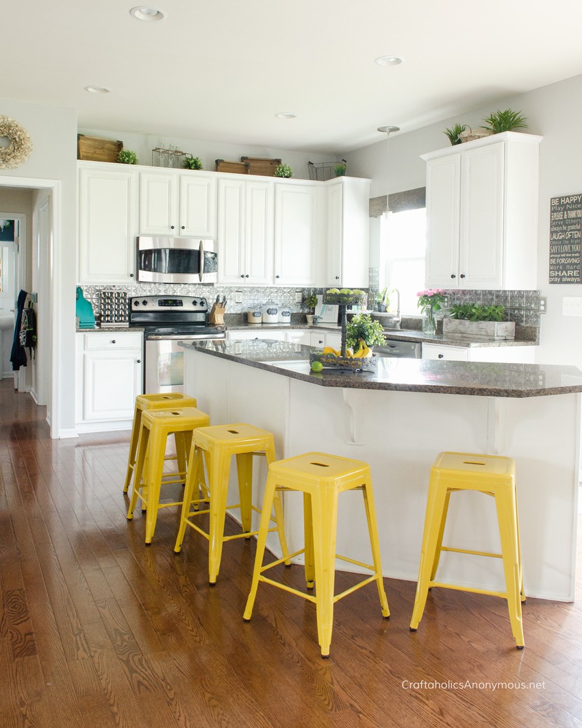 DIY painted kitchen cabinets :: She used a no prep, no priming method. Such an easy way to do it!