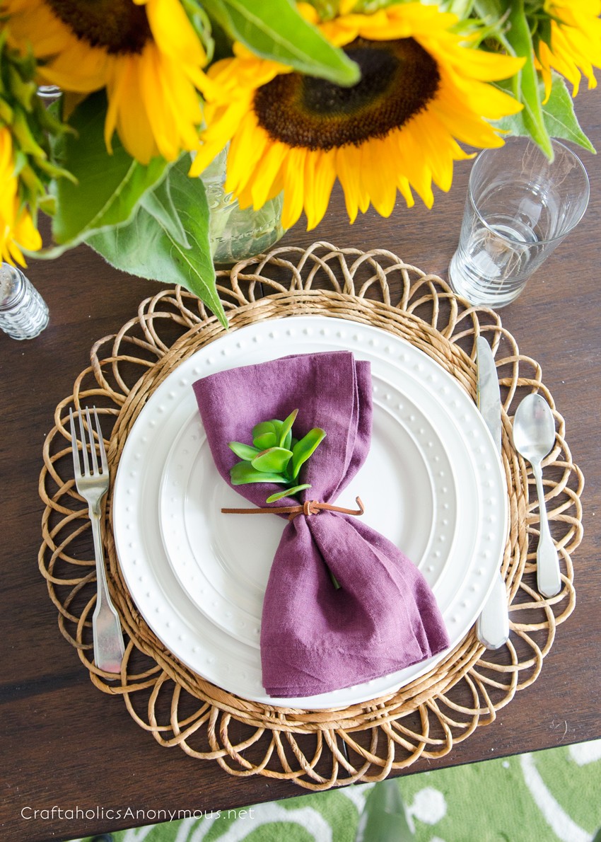 Beautiful Fall Place Setting idea with sunflowers and plum colored napkins